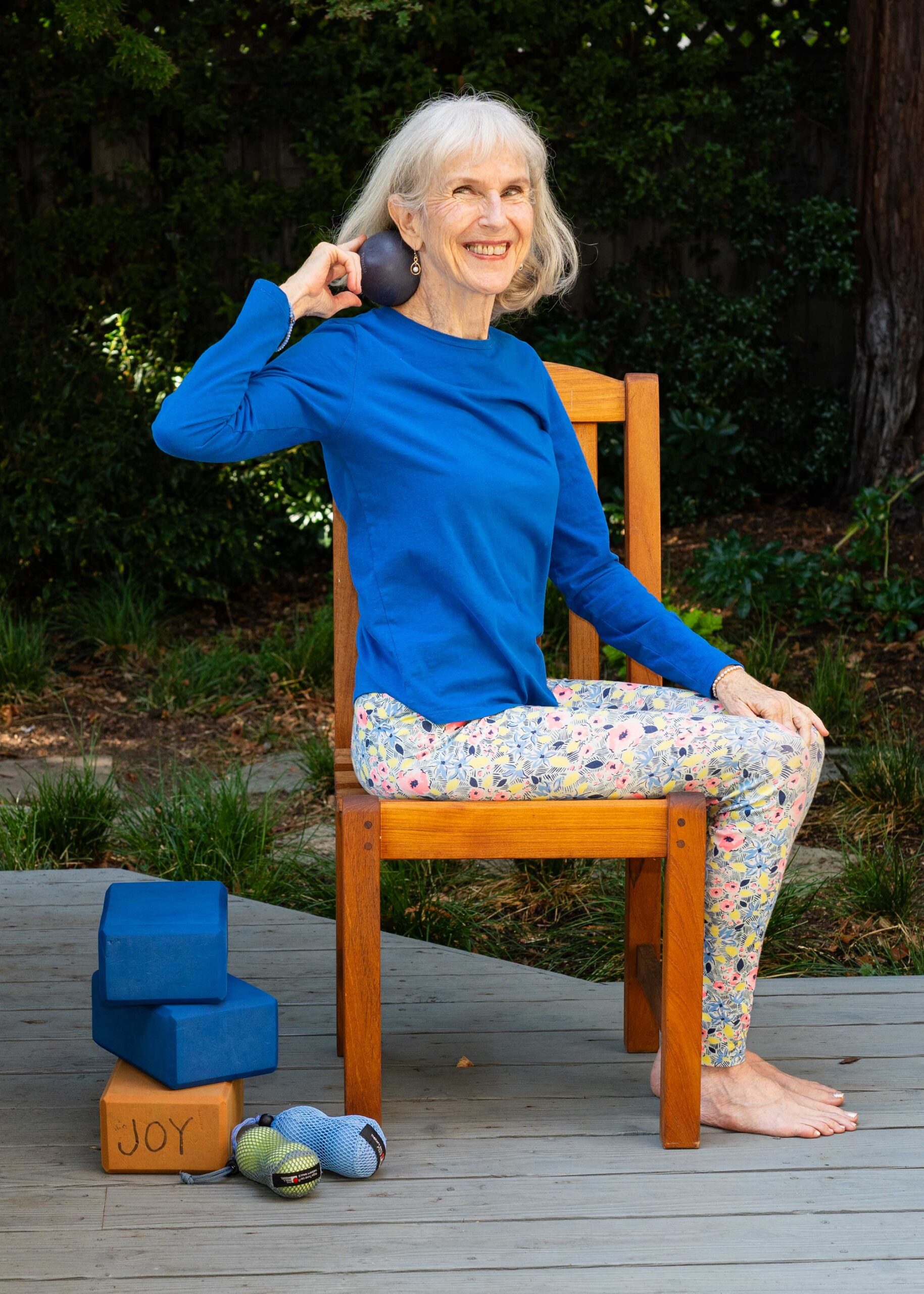 Patricia Becker with alpha ball by neck other balls beside her chair . size reduced