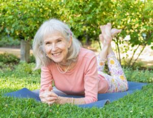 Patricia Becker practicing yoga outdoors to promote healthy aging for adults 50+